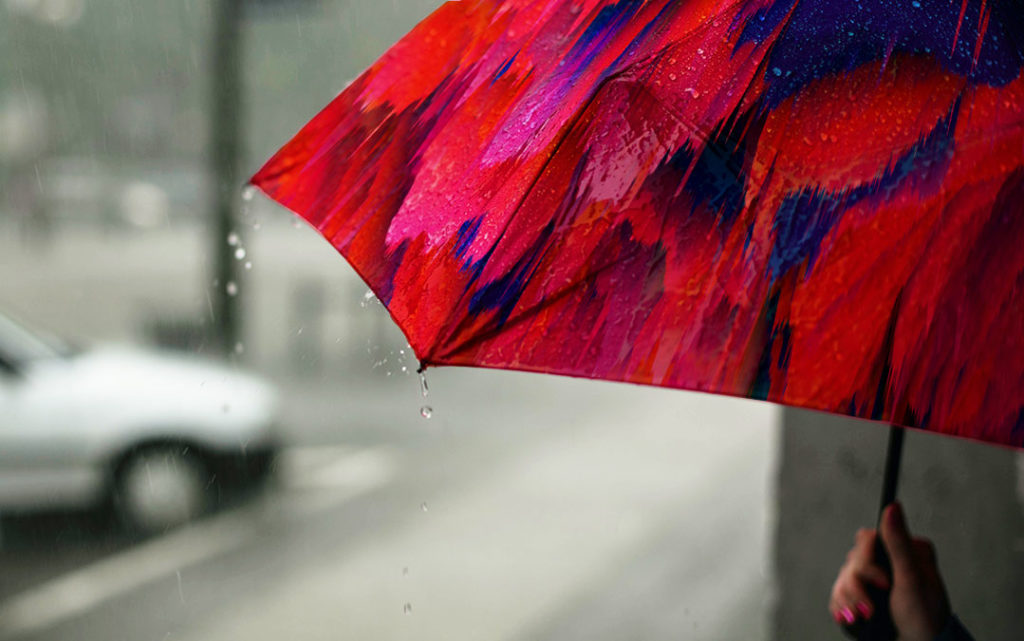 Raindrops on a brightly colored umbrella