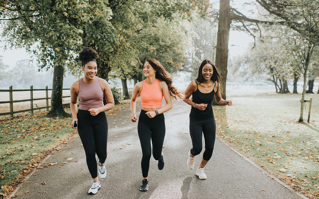 Three women jogging in a park
